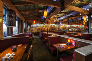 Coastal Flats dining room with lofted ceilings multicolored mural Forrester Construction