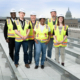 Forrester Construction DC Courts C Street Team posing on roof of project in front of the Washington DC Capitol Building