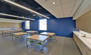 Sterling community center art room with stools and tables blue accent wall Forrester Construction