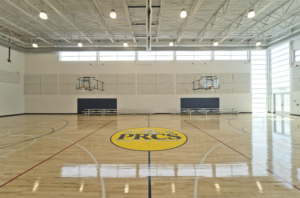 Sterling Community Center gymnasium wooden floor with PRCS emblem on floor white walls Forrester Construction