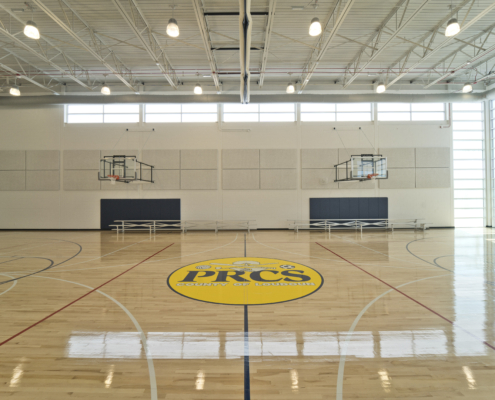 Sterling Community Center gymnasium wooden floor with PRCS emblem on floor white walls Forrester Construction