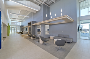 Sterling community center lobby gray wall and chairs high ceiling seating area Forrester Construction