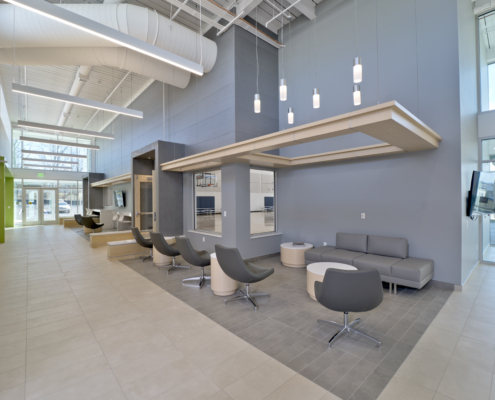 Sterling community center lobby gray wall and chairs high ceiling seating area Forrester Construction