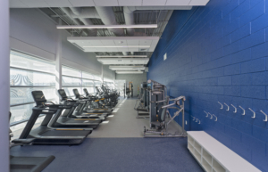 Sterling Community Center fitness center treadmills blue accent wall Forrester Construction