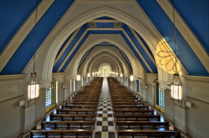 Corpus christi catholic church interior blue vaulted ceilings with church pews Forrester Construction